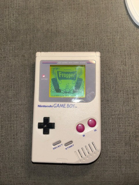 Rear of classic gray Nintendo Game Boy Unit B with battery cover in place