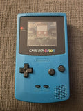 Teal Nintendo Game Boy Color displaying the Frogger title screen