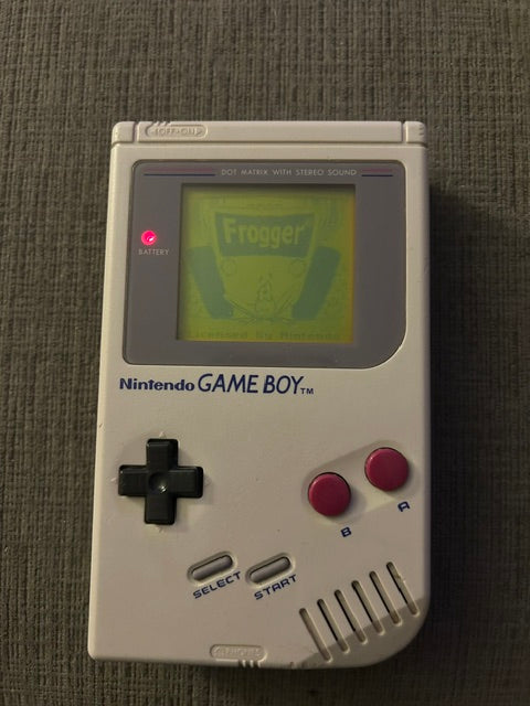 Front of classic gray Nintendo Game Boy Unit E displaying Frogger