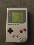 Front of classic gray Nintendo Game Boy Unit E displaying Frogger